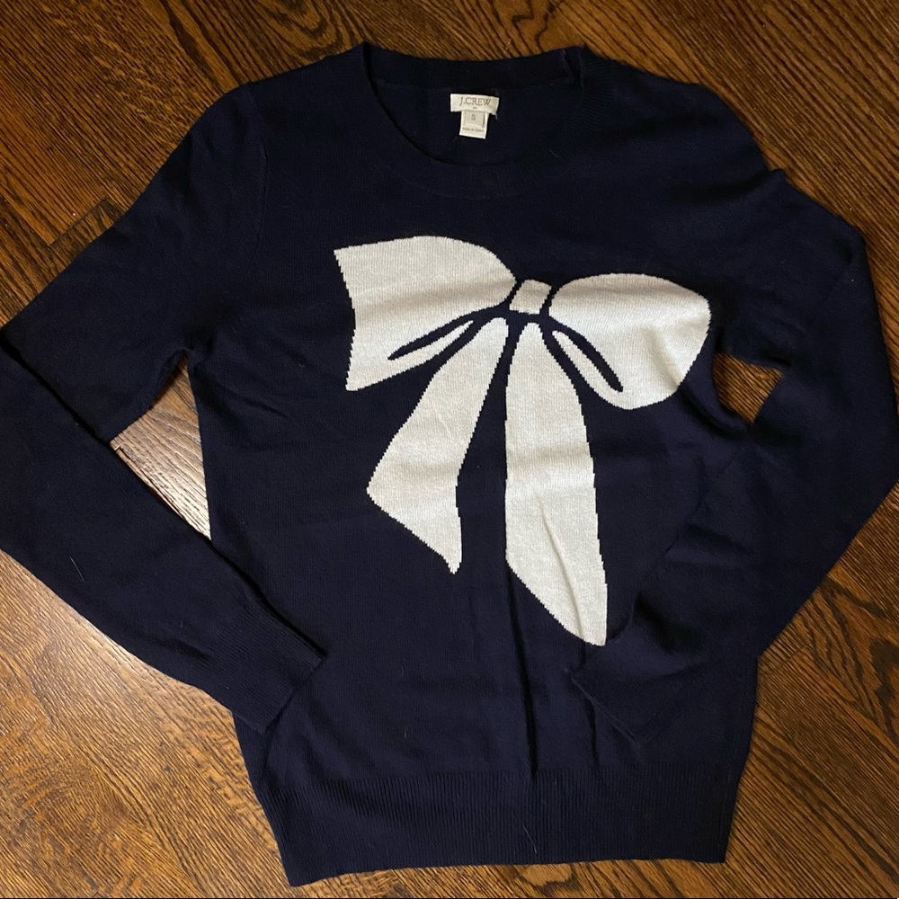 J. Crew navy sweater with large white bow design